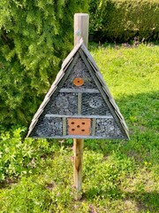 View of insect hotel in garden.