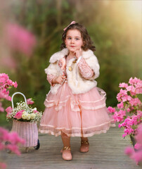 little girl in a pink dress with pink flower