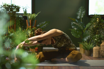 stylish woman at modern green home stretching