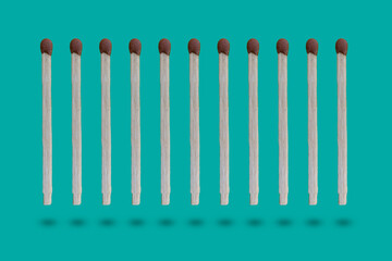 row of the wooden matches in the air on colorful background