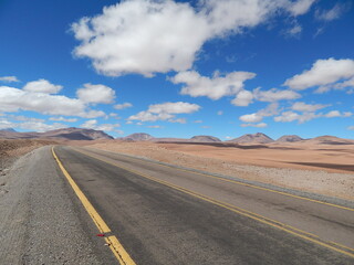  road in the Atacama Desert,  colorful blue sky with clouds . Atacama Desert, Chile, South America