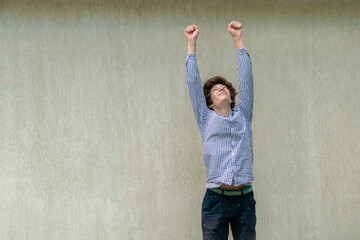 young man jumping high, winning or success gesture signs