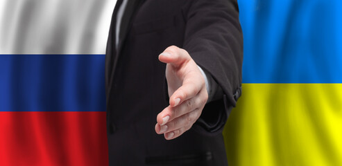 Open hand on flags of Ukraine and Russia background. Peace talks concept