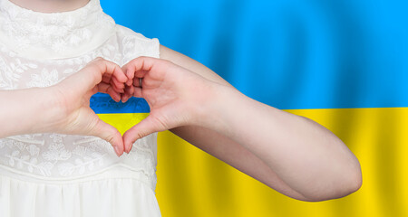 Woman making heart with Ukrainian flag on flag of Ukraine background