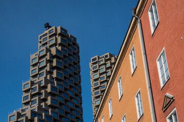 Fototapeta na wymiar Stockholm, Sweden April 2, 2022 The new Norra Tornen residential building contrasts with older more tradiotinal architecture.