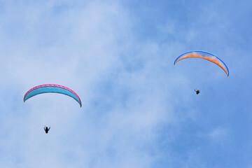 	
Paragliders in a blue sky	