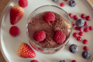 Chocolate mousse with raspberries and strawberries in a glass