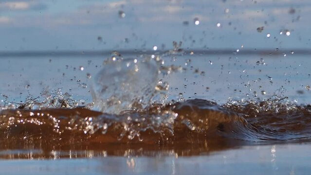 The stone is thrown into the water. Stonhe falls into the pond, visible circles on the water.
