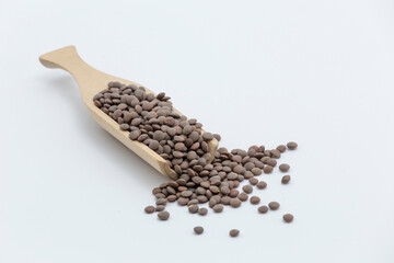 raw lentils on a wooden pallet on a white surface