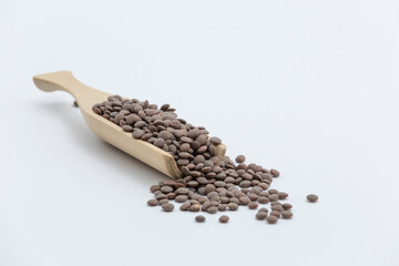raw lentils on a wooden pallet on a white surface
