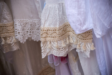 Closeup of boho style clothes on hangers at the market