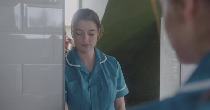 Pretty Nurse Looking in Mirror, Getting Ready for Work