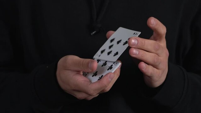 Poker game-stuffing cards. Man's hands shuffling playing cards. Dealer's hands shuffling cards during a poker game. 