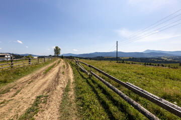 Fototapeta na wymiar Mountain dirt road in the Ukrainian Carpathians on a summer day.