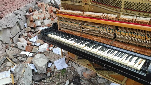 Chernihiv, Ukraine - April 17, 2022: Russia's war against Ukraine. Destroyed piano and thrown out by the blast from an apartment building after an airstrike.