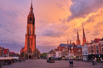 Nieuwe Kerk New Church protestant church on Delft Market Square Markt with dramatic sky on sunset....