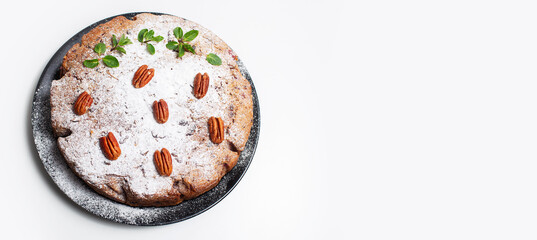 Vegan food. Homemade pie in black plate on white table. Banner with copy space.
