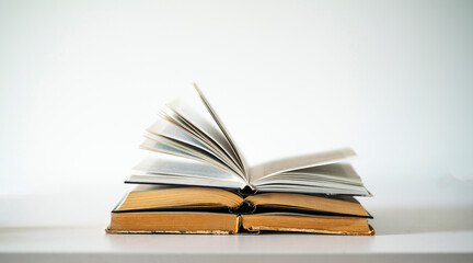 opened old book on the table as the symbol of wisdom and knowledge, education concept