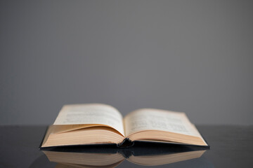 opened old book on the table as the symbol of wisdom and knowledge, education concept