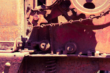 Rusty industrial machine abandoned outdoors on a rural farm.