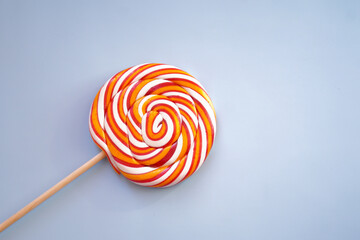 Multicolored lollipop. Holiday. Blue background.