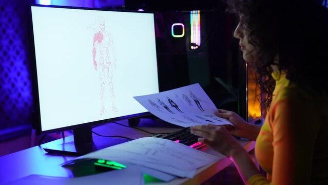 Business concept of 4k Resolution. Asian female designer working in office. Designing clothes and characters in online games.