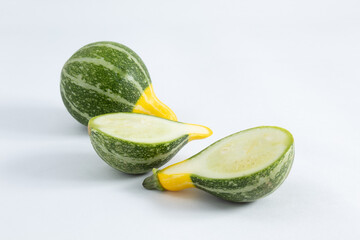 Small green and yellow Brazilian zucchini, accompanied by two halves