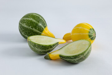 Small portion of Brazilian zucchinis, with green and yellow colors, on a white background