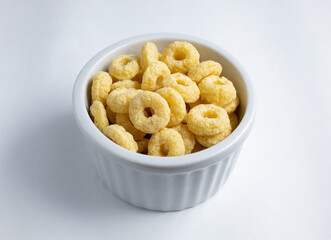 Delicious yellow loops breakfast cereal served in white ramekin