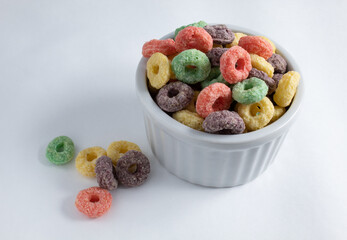 Portion of colorful fruit breakfast cereal, without milk, on white background