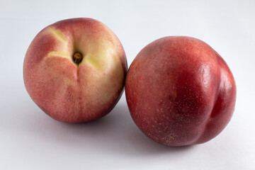 Delicious ripe and fresh nectarines. Whole, sweet and raw. On white background