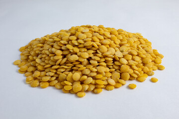 Portion of raw yellow lentils on white background. Healthy and delicious vegetables