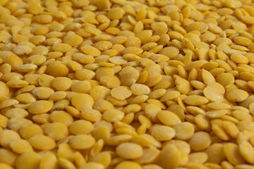 Raw yellow lentils texture. Healthy and delicious vegetables