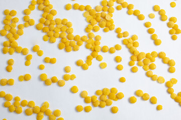 Texture of raw yellow lentils scattered on white background