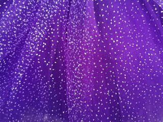 Naklejka na ściany i meble Purple colored fabric with small glitter stones