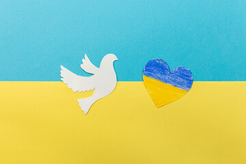 Peace dove with heart in flag colors of Ukraine. No war, stop war