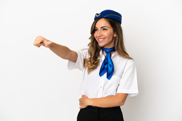 Airplane stewardess over isolated white background giving a thumbs up gesture