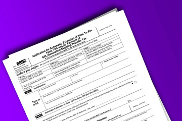Form 8892 documentation published IRS USA 43747. American tax document on colored - obrazy, fototapety, plakaty