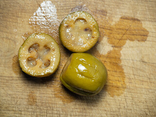 Canned feijoa. The fruit of a tree with seeds. Compote preparation. Cut feijoa