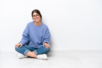 Young caucasian woman sitting on the floor isolated on white background laughing - Powered by Adobe