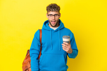 Young student blonde man isolated on yellow background with surprise facial expression