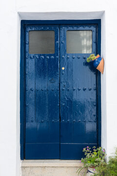 Beautiful, blue door with studs and plants in Frigiliana. Malaga, Andalusia, Spain