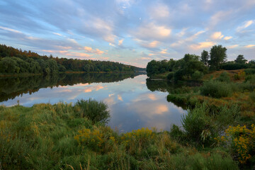 reflection of trees in water,  evening on the Strizhen river in Chernihiv, Ukraine