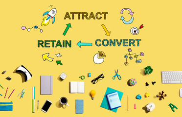 Attract convert retain concept with collection of electronic gadgets and office supplies