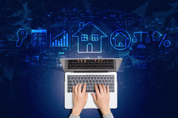 Real estate theme with person using a laptop computer - obrazy, fototapety, plakaty
