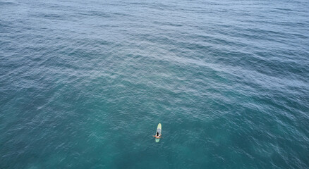 Aerial view of the ocean and surfer girl. Surfing in Midigama. Sri Lanka