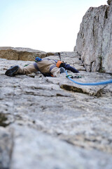 Male climber climbing a vertical mountain wall