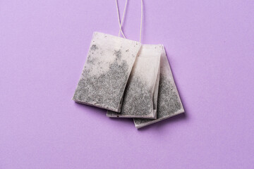 Three tea bags on a table.