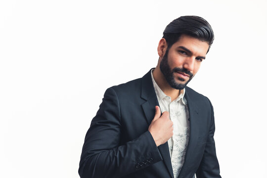 Latin Caucasion bisnessman man poising and adjusting his jacket, medium portrait isolated white background. High quality photo