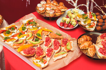 Catering table, beautifully decorated banquet with variety of with different food snacks and appetizers on corporate birthday party event or wedding celebration, delicatessen setting